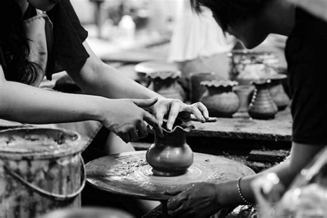 Premium Photo Midsection Of Women Molding Pot In Workshop