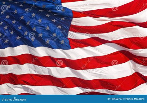 A Red White And Blue American Flag Waving In The Wind Stock Image