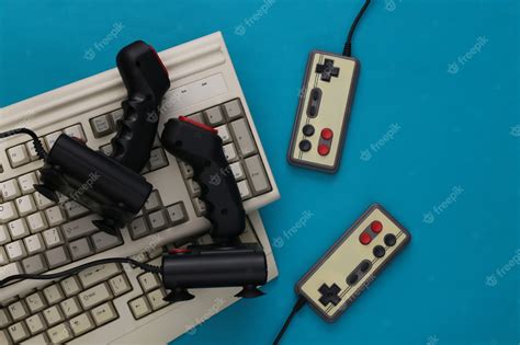 Premium Photo Old Keyboard Joysticks And Gamepads On Blue Background