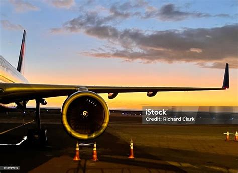 A Plane At Sunset Stock Photo - Download Image Now - Aircraft Wing, Airplane, Airport - iStock