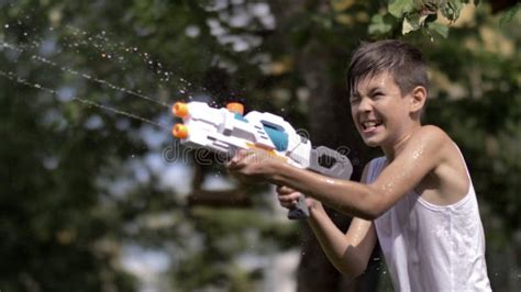 Happy Funny Boy Shoots a Water Pistol Outdoors Stock Image - Image of elementary, daylight ...