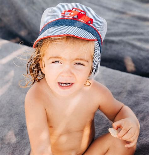 Premium Photo Portrait Of Cute Shirtless Girl Sitting Outdoors