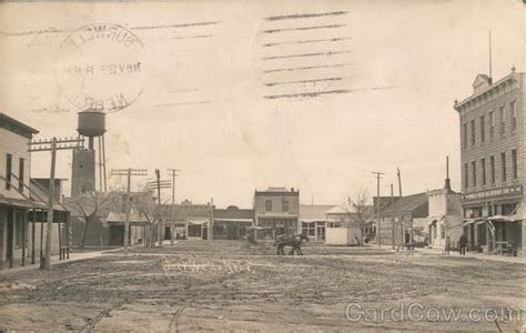 Main Street view dirt road Burwell, NE Postcard