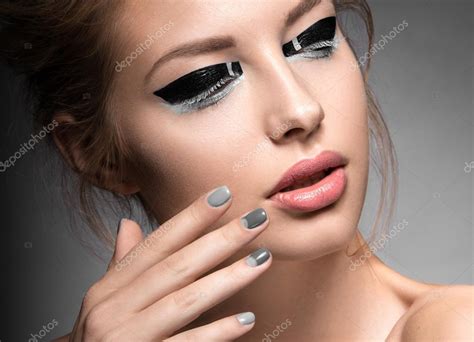 Beautiful Girl With Bright Creative Fashion Makeup And Grey Nail Polish