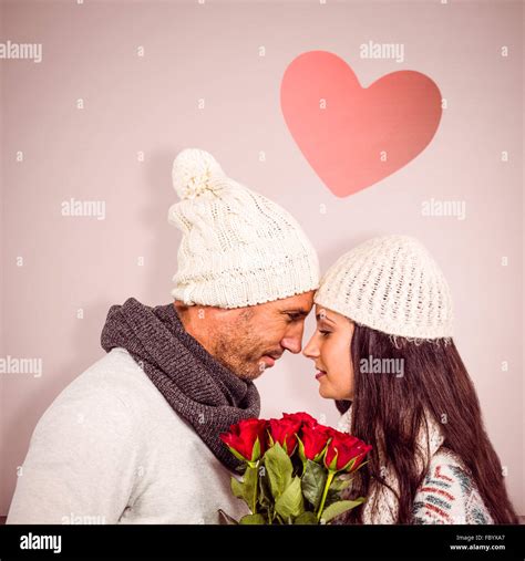 Composite Image Of Smiling Couple Nose To Nose Holding Roses Bouquet