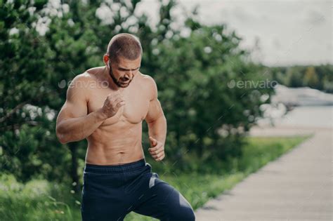 Active Bearded Man Has Active Exercises Outdoor Runs On One Place Has