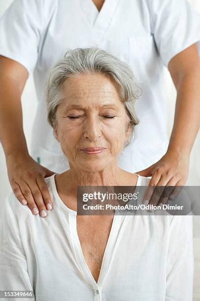 Woman Massaging Shoulder Photos And Premium High Res Pictures Getty