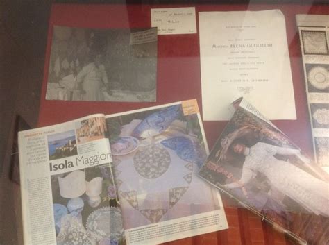 An Assortment Of Items On Display In A Glass Case Including Magazines