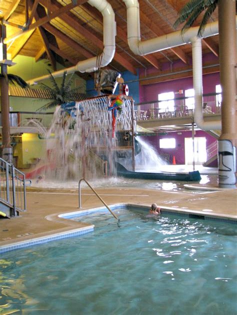 an indoor swimming pool with slides and water features