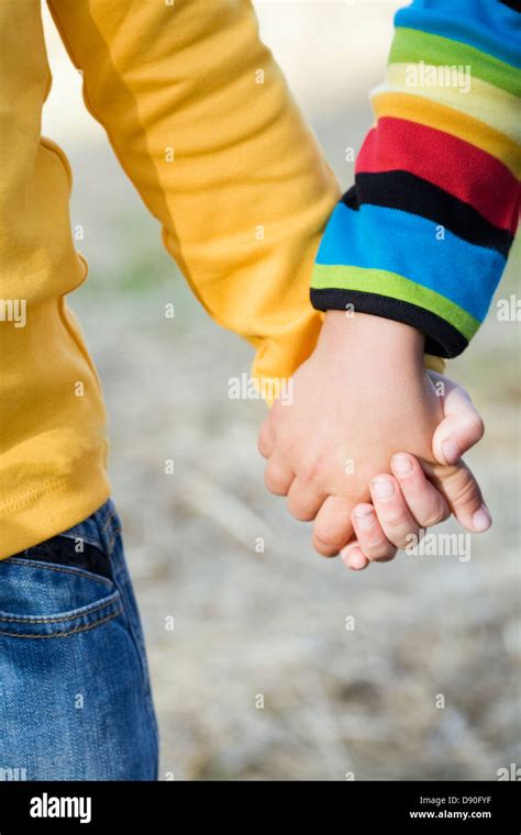 Friends holding hands Stock Photo - Alamy