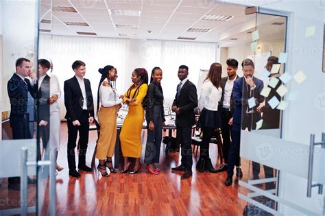 Large Group Of Eleven Multiracial Business People Standing At Office