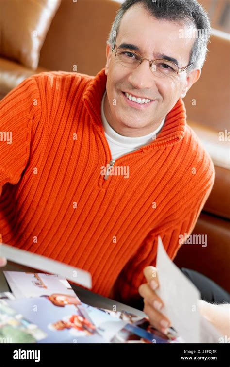 Portrait Of A Mid Adult Man Holding A Photograph And Smiling Stock