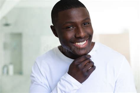 Portrait Of Happy African American Man Smiling To Camera In Bathroom