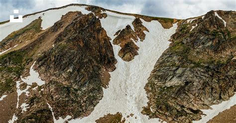 A snow covered mountain with a sky background photo – Free Beartooth ...