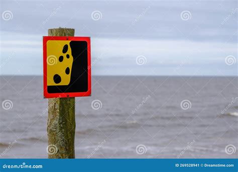 A Warning Sign about a Possible Landslide Near the Seashore. Reflects ...