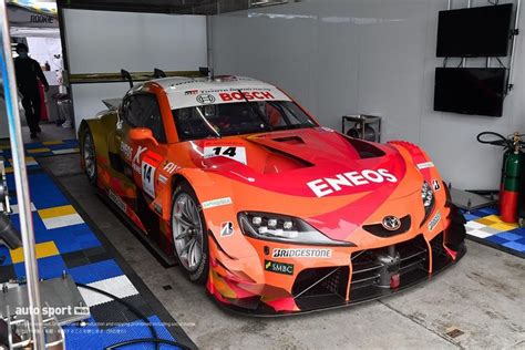 An Orange Sports Car Parked In A Garage