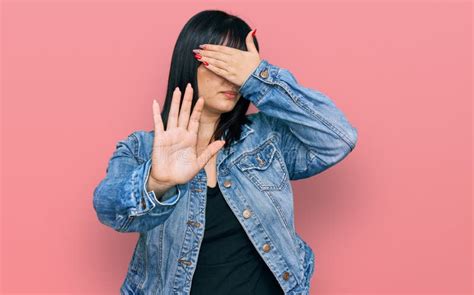 Young Hispanic Woman Wearing Casual Clothes Covering Eyes With Hands