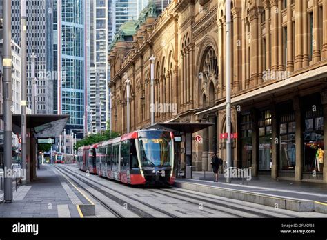 The Electric Light Rail Tram System Passing The Qvb On George Street