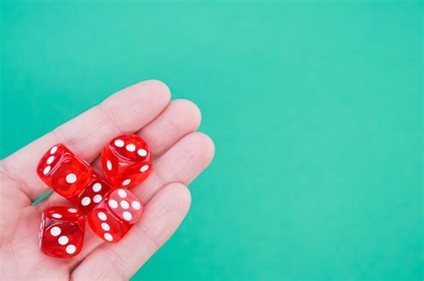 Premium Photo Closeup Of Red Rolling Dice On A Blue Background