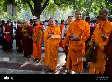 Monks Wearing Red And Orange Robes And Buddhist Dignitaries From Laos