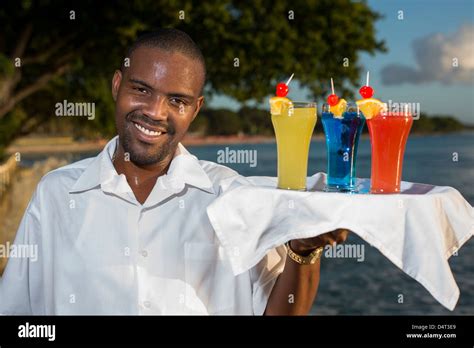 A Waiter Holding A Tray Of Cocktail Drinks On The West Coast Of