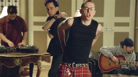 Two Men In Plaid Pants And Black Shirts Are Playing Music On Their