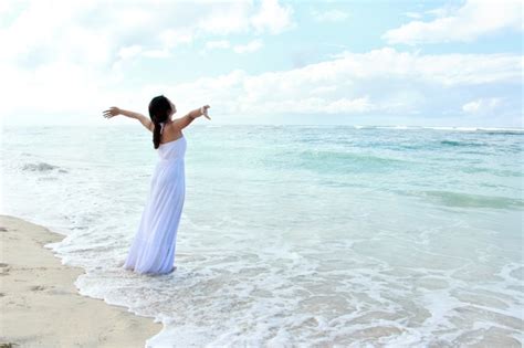 Premium Photo Woman Relaxing At The Beach With Arms Open