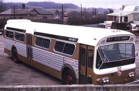 an old bus parked in a parking lot