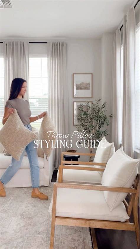 A Woman Holding Pillows In Her Living Room