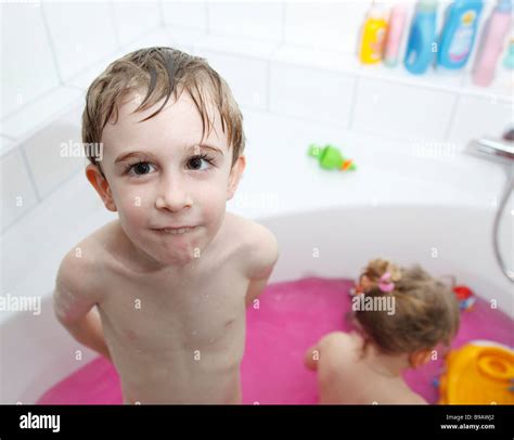 Boy Standing In Bath Tub With Pink Water Stock Photo Alamy