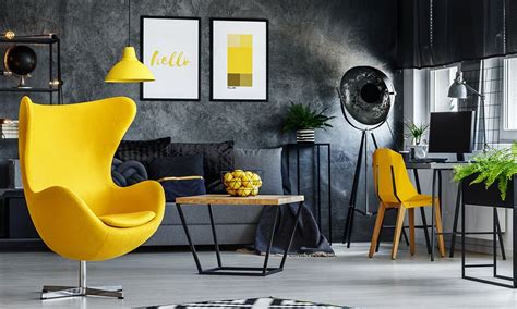 A Living Room Filled With Yellow Chairs And Black Furniture In Front Of