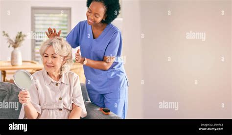 Nurse Senior Woman And Hair Care By Mirror In Home Living Happy For