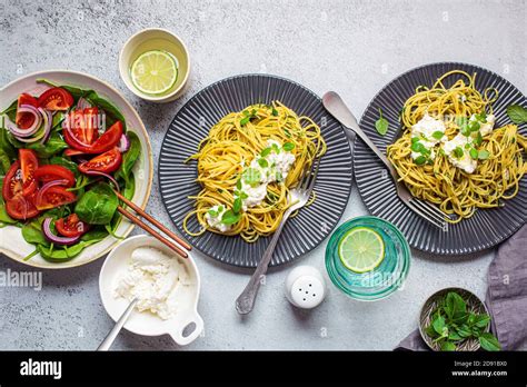 Family lunch table, top view. Italian pasta with ricotta and fresh ...