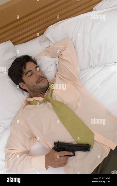 Man Bed Holding Gun Hi Res Stock Photography And Images Alamy