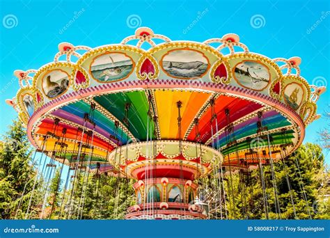 A Rainbow Colored Swing Carousel At An Amusement Park Stock Image