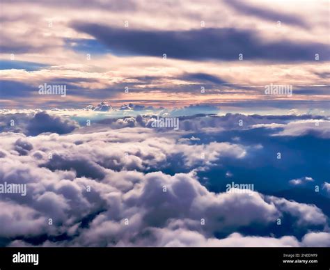 View From Above The Fluffy Nimbus Clouds And Horizon At Sunset High Up