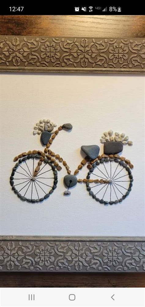 An Image Of A Bike Made Out Of Wood Beads On A White Wall In A Frame