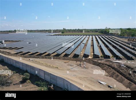 An Aerial View Of A Large Scale Solar Farm With An Array Of Black Solar