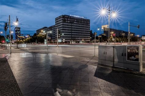 An Empty City Street At Night With The Lights Turned On And Buildings