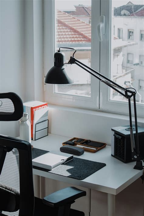 A desk with a lamp and a computer on it photo – Free Grey Image on Unsplash