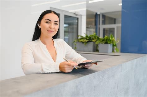 Premium Photo Portrait Of Beautiful Receptionist Near Counter In Hotel