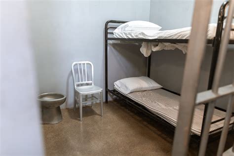 A Bunk Bed With Striped Foam Mattress in a Prison Cell · Free Stock Photo