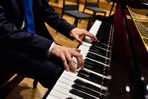 Pianist Playing A Piece On A Grand Piano At A Concert Seen From The