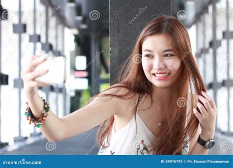 Thai Adult Beautiful Girl Using Her Smart Phone Selfie Stock Image