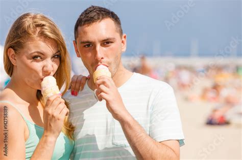 Man And Woman Eating Ice Cream On Beach Stock Photo And Royalty Free