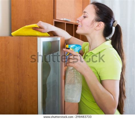 Brunette Woman Dusting Wooden Furiture Rag Stock Photo