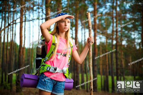 Teenage Girl Traveler With Backpack Climb In Hill Forest Stock Photo