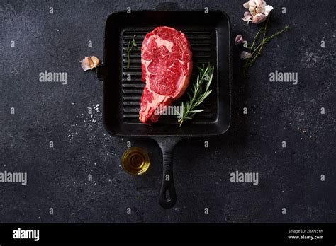 Top View Black Angus Prime Beef Rib Eye Steak On Cast Iron Grill Pan