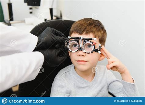 Cheerful Child Boy In Glasses Checks Eye Vision Pediatric