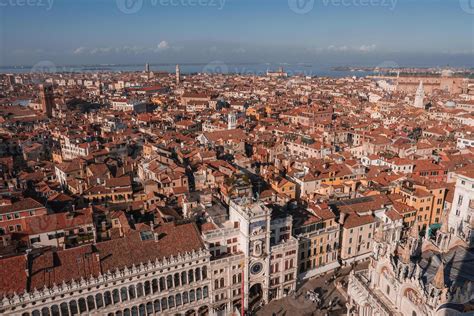 Aerial view of Venice, Italy showcasing red-roofed buildings, gondolas ...